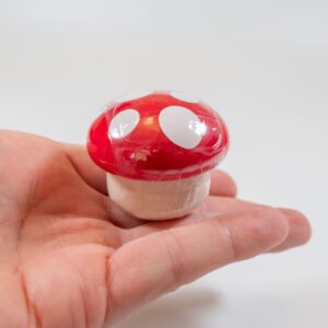 Strawberry lip balm in a cute tiny mushroom in hand