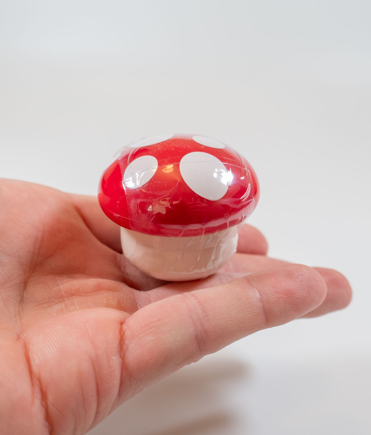 Strawberry lip balm in a cute tiny mushroom in hand