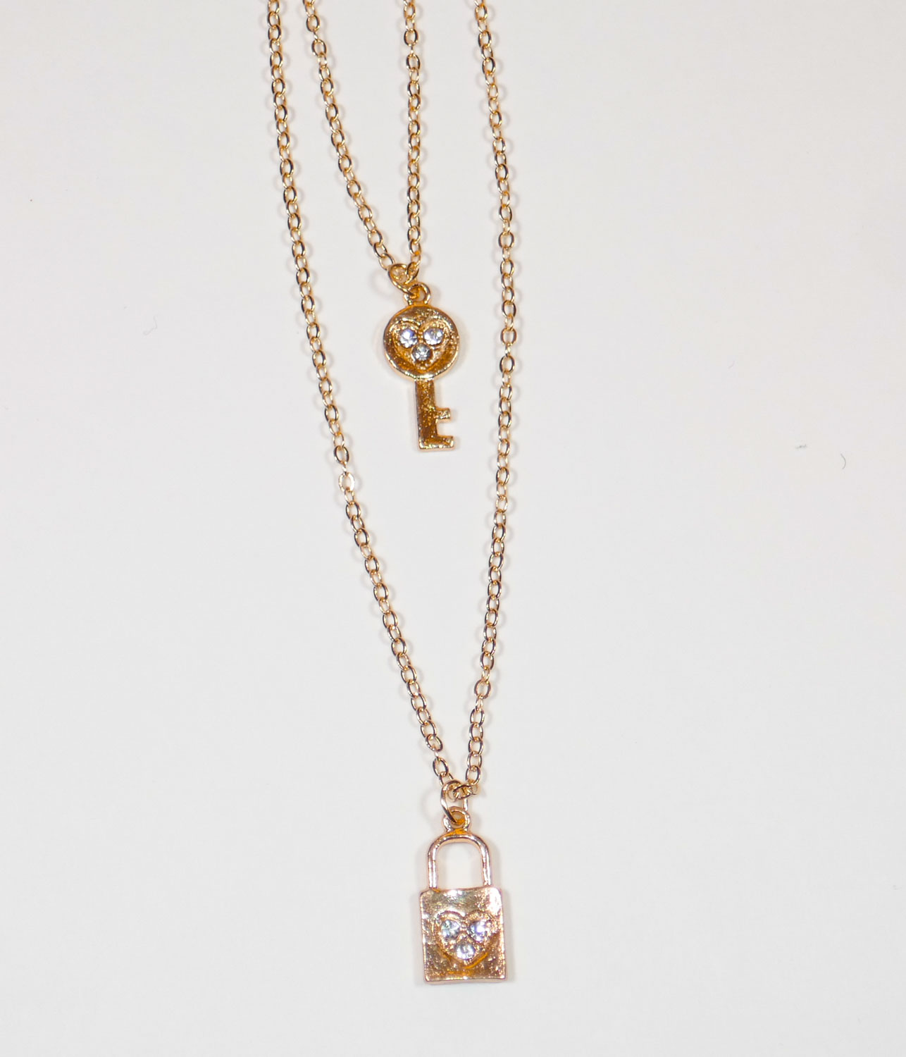 Lock and Key gold necklace on girls neck, beautiful teen jewelry gifts close up