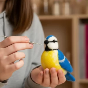 Person needle felting a blue tit bird using wool and felting needle, beginner DIY craft kit project