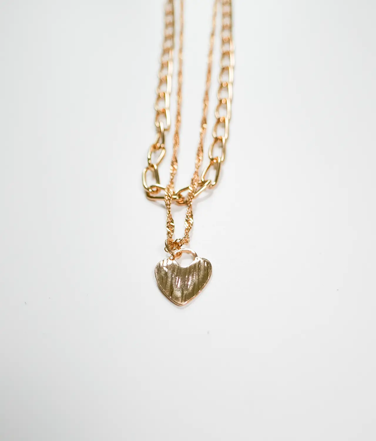 Double chain gold necklace with heart - closeup