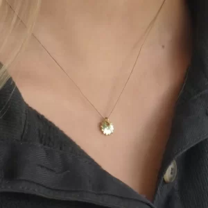 Gold sunshine pendant necklace - on girls neck