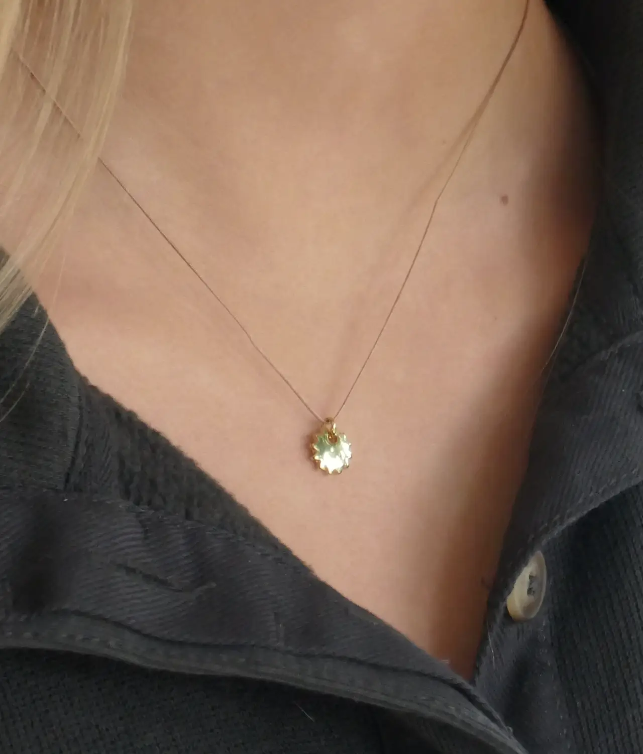 Gold sunshine pendant necklace - on girls neck