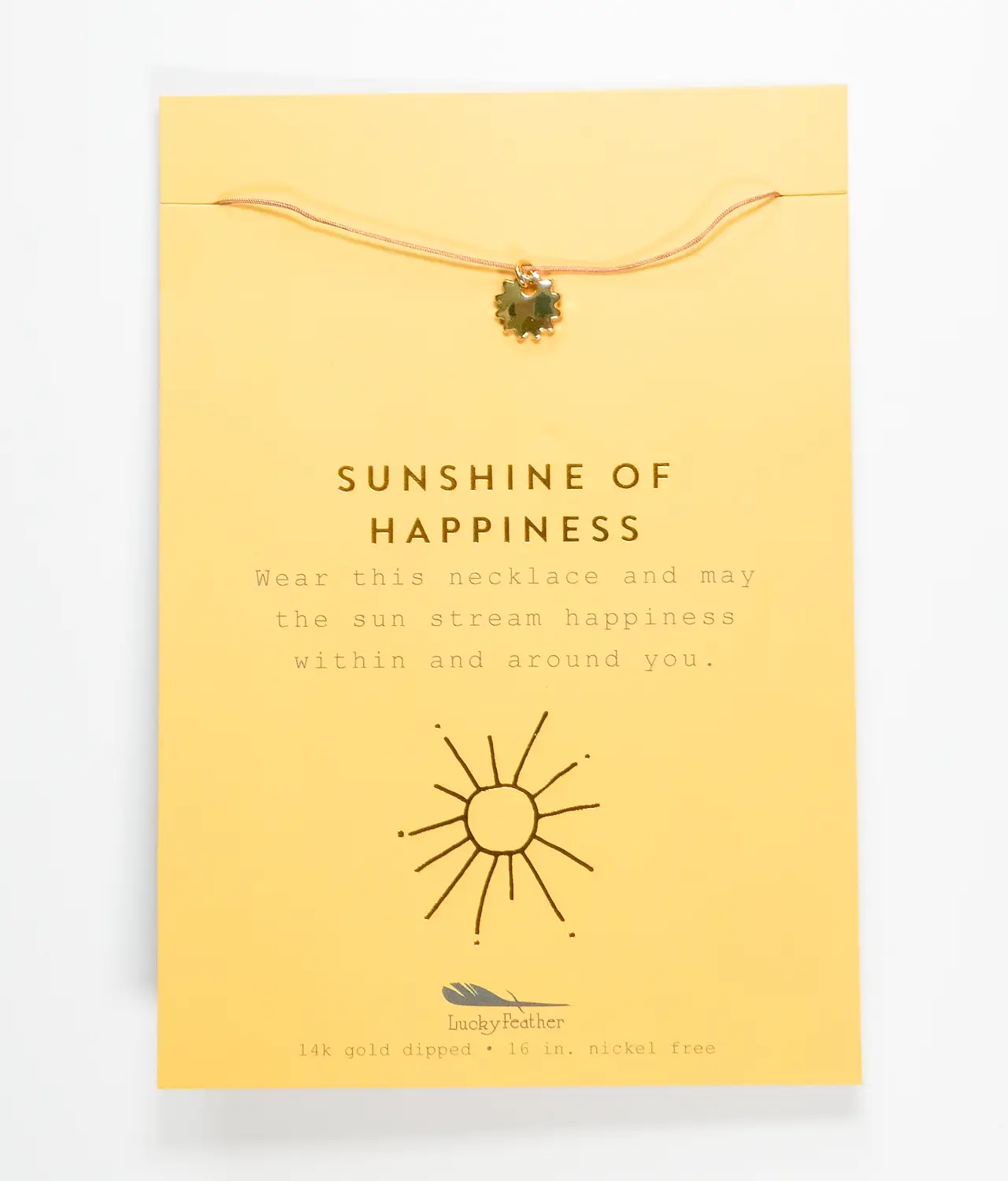 Gold sunshine pendant necklace on package