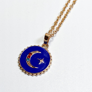 Close-up of celestial moon necklace with gold-toned chain and star detail